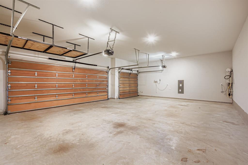 312 Magnolia Drive Oak Point, TX 75068 - Photo 24 of 28 Garage with electric panel and a garage door opener