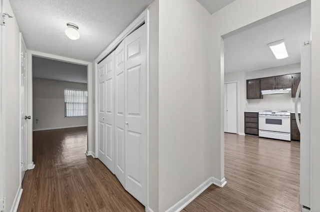 a view of a hallway with wooden floor