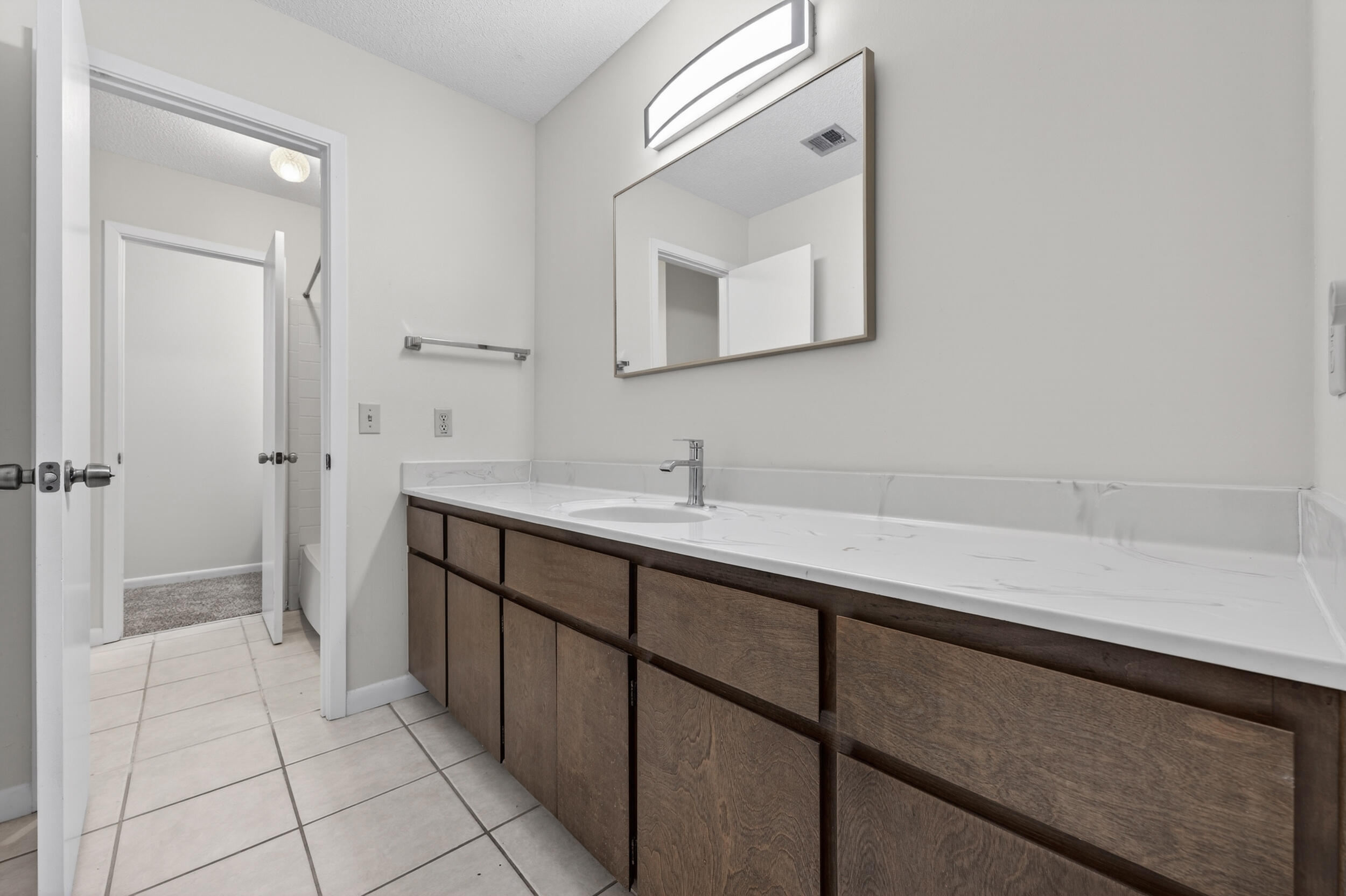 132 5th Avenue Shalimar, FL 32579 - Photo 20 of 39 a spacious bathroom with a sink a mirror and a shower