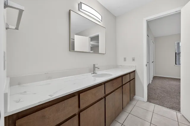 a bathroom with a double vanity sink and a mirror
