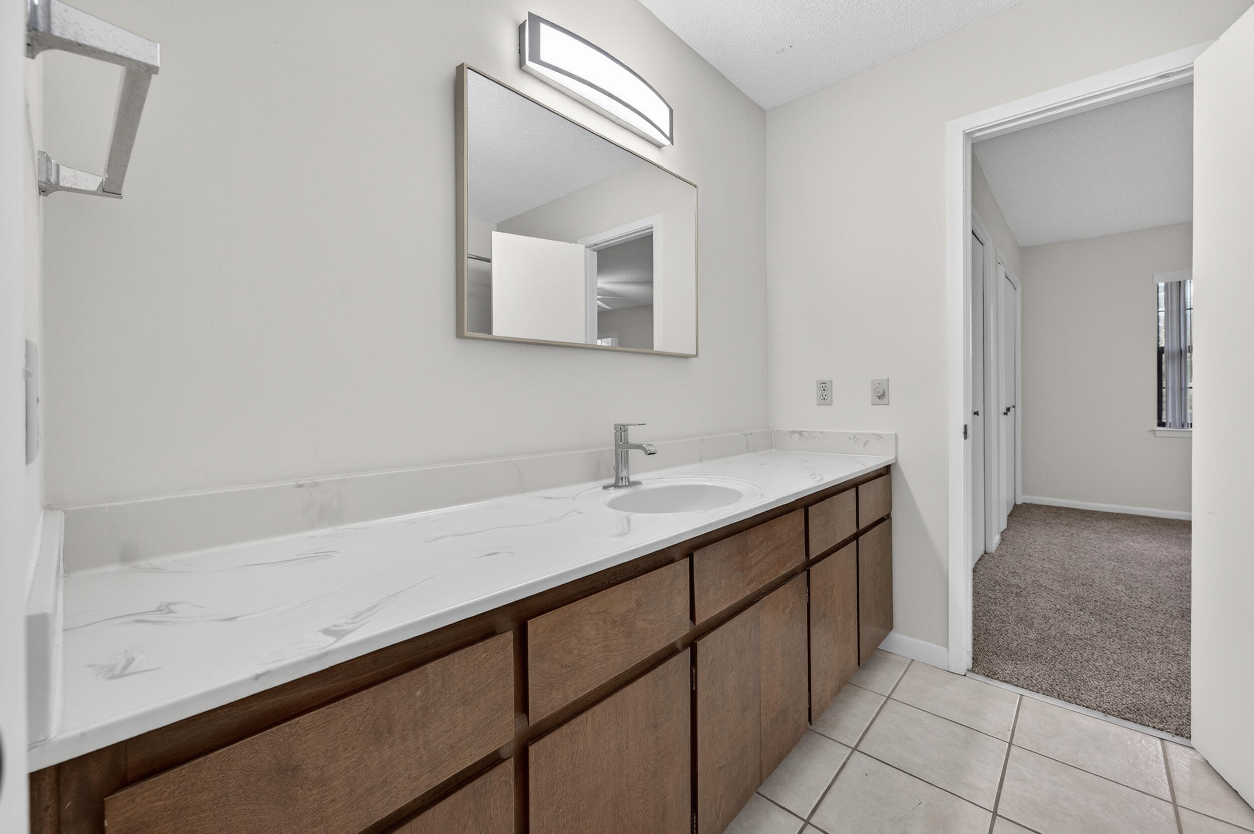 132 5th Avenue Shalimar, FL 32579 - Photo 23 of 39 a bathroom with a double vanity sink and a mirror
