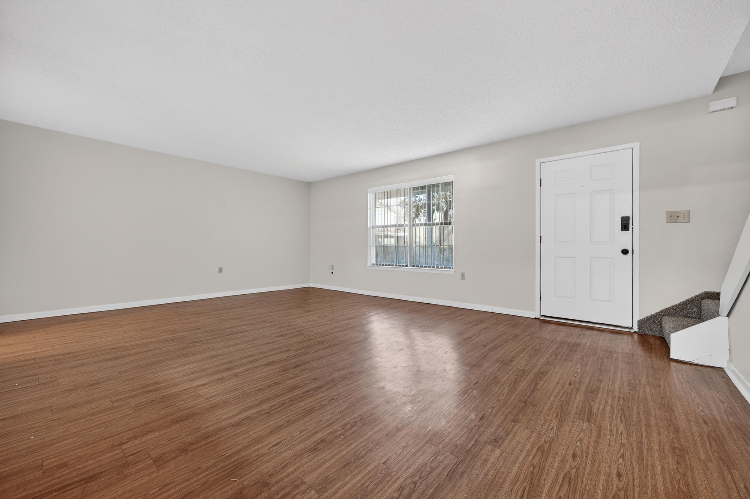 132 5th Avenue Shalimar, FL 32579 - Photo 6 of 39 a view of an empty room with wooden floor and a window