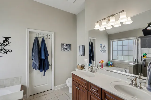 a bathroom with a sink a large mirror and a shower
