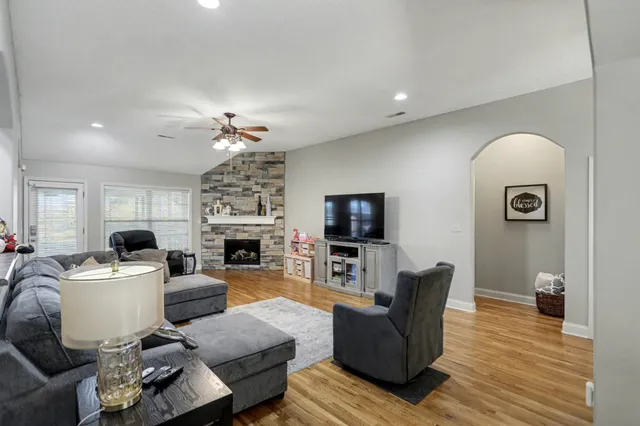 a living room with furniture a fireplace and a flat screen tv