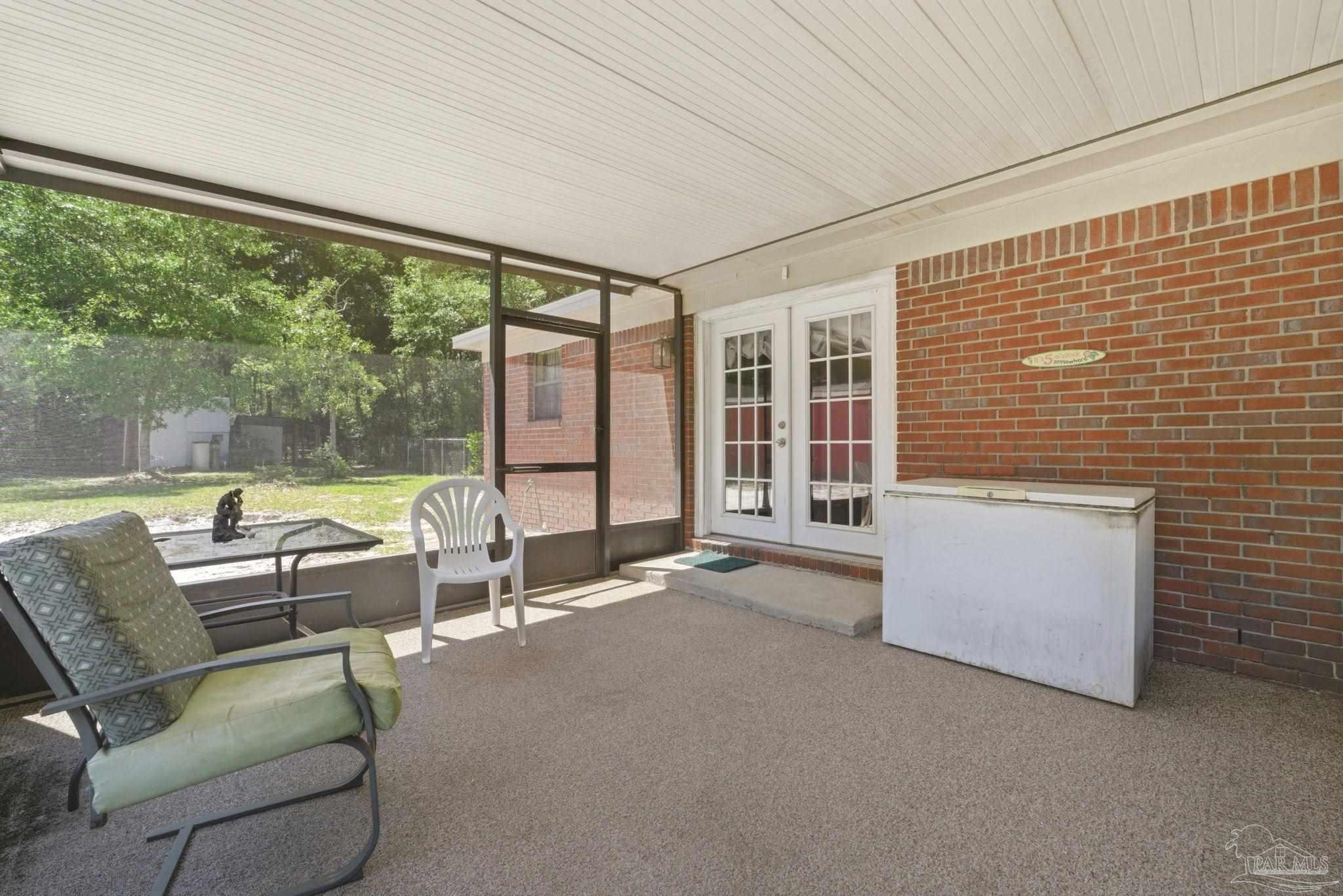 5121 Keyser Mill Road Baker, FL 32531 - Photo 30 of 52 a living room with furniture and a floor to ceiling window