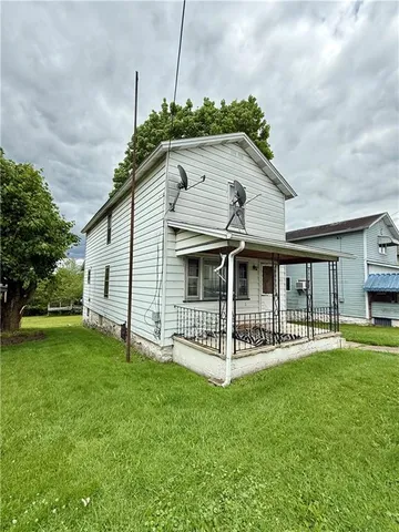 a view of a house with a yard and deck