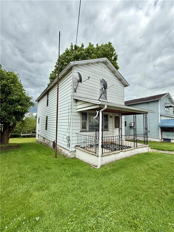 a view of a house with a yard and deck