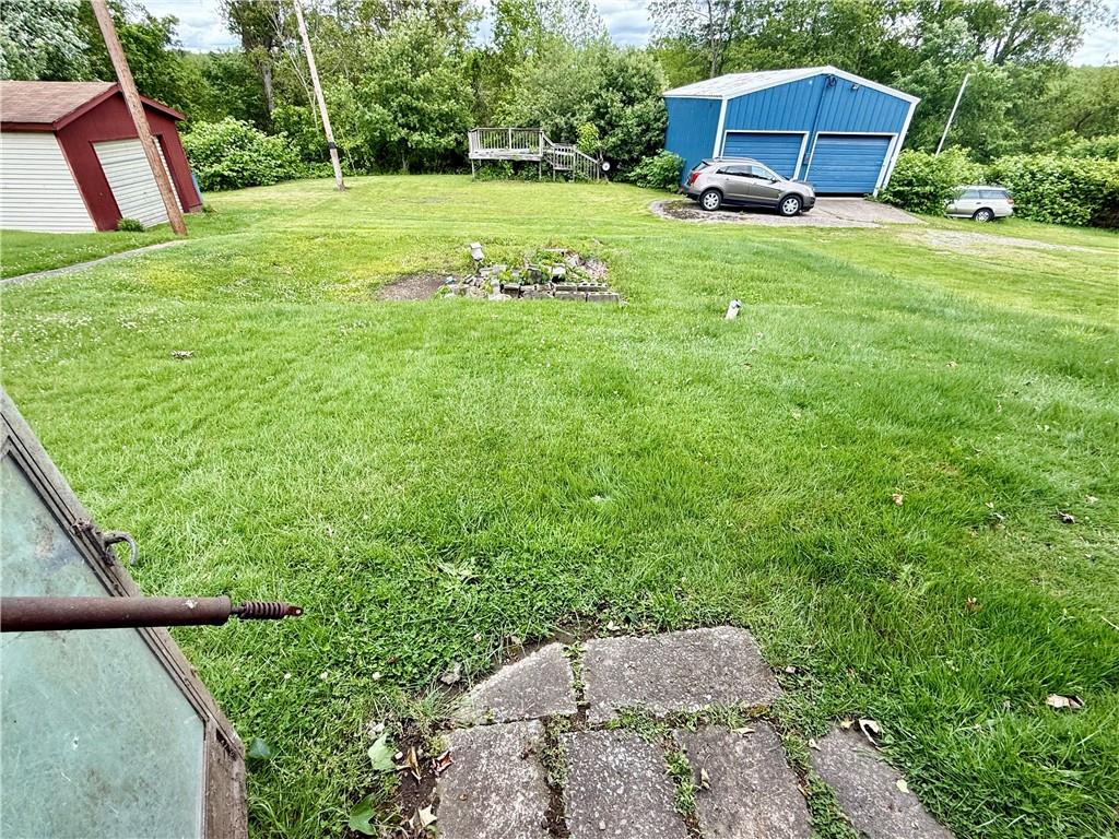 411 East Avenue Allison, PA 15413 - Photo 16 of 19 a view of a backyard with table and chairs and wooden fence