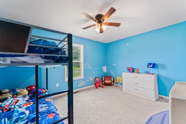 a storage room with furniture and a ceiling fan