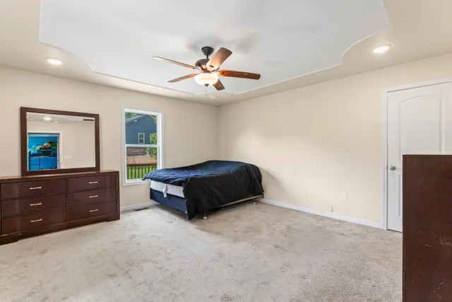 a bedroom with a bed and a dresser