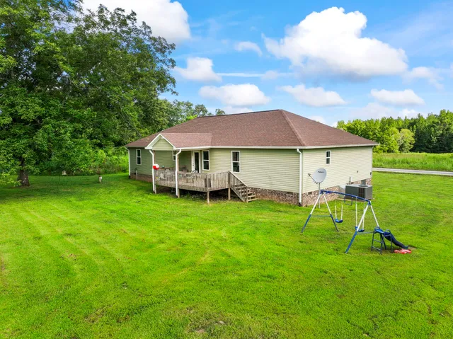 a view of house with backyard and outdoor