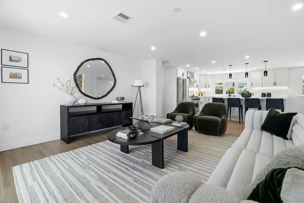 a living room with lots of furniture and a large window