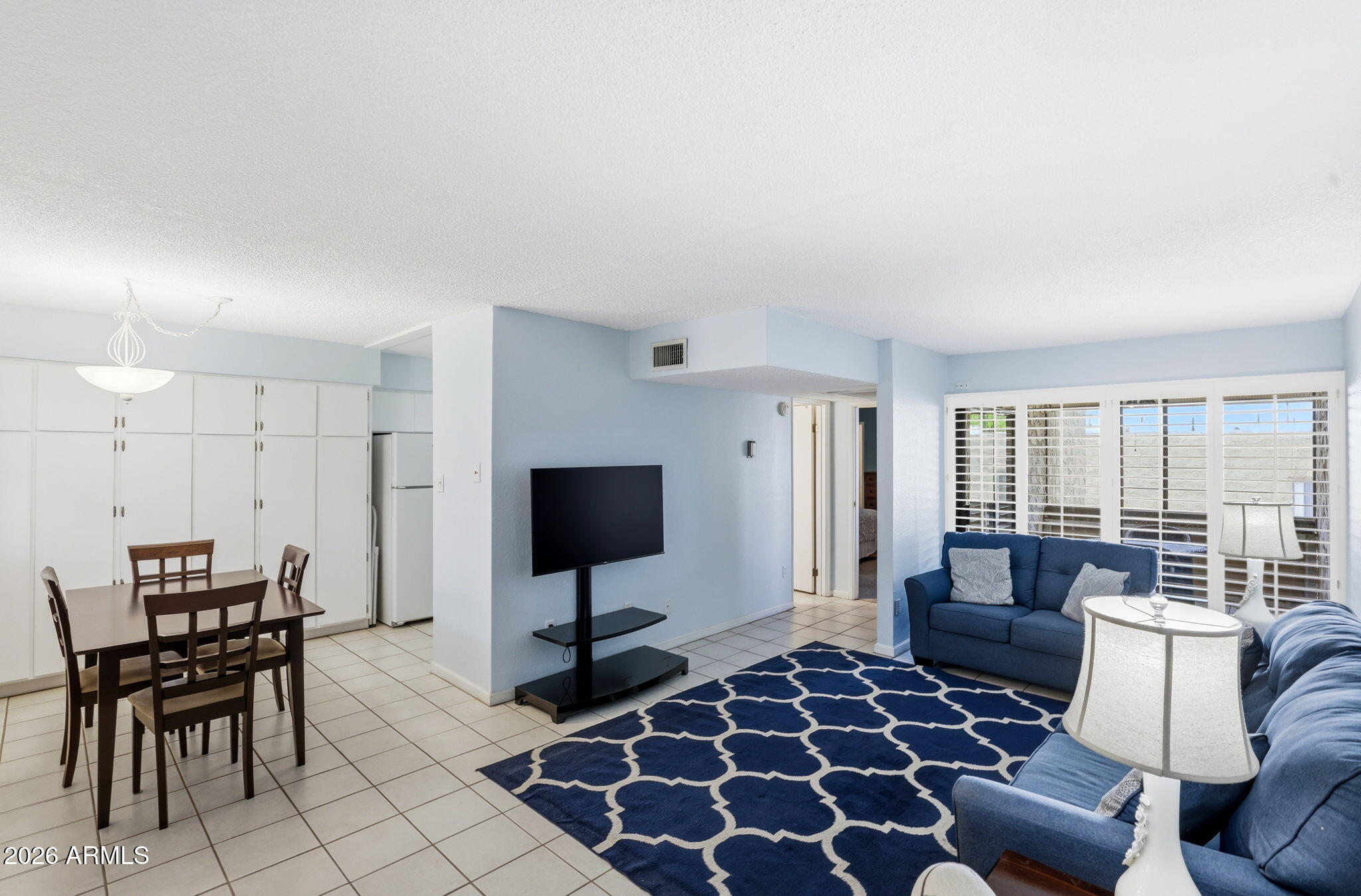 4950 North Miller Road, Unit 339 Scottsdale, AZ 85251 - Photo 11 of 28 a living room with furniture and a flat screen tv