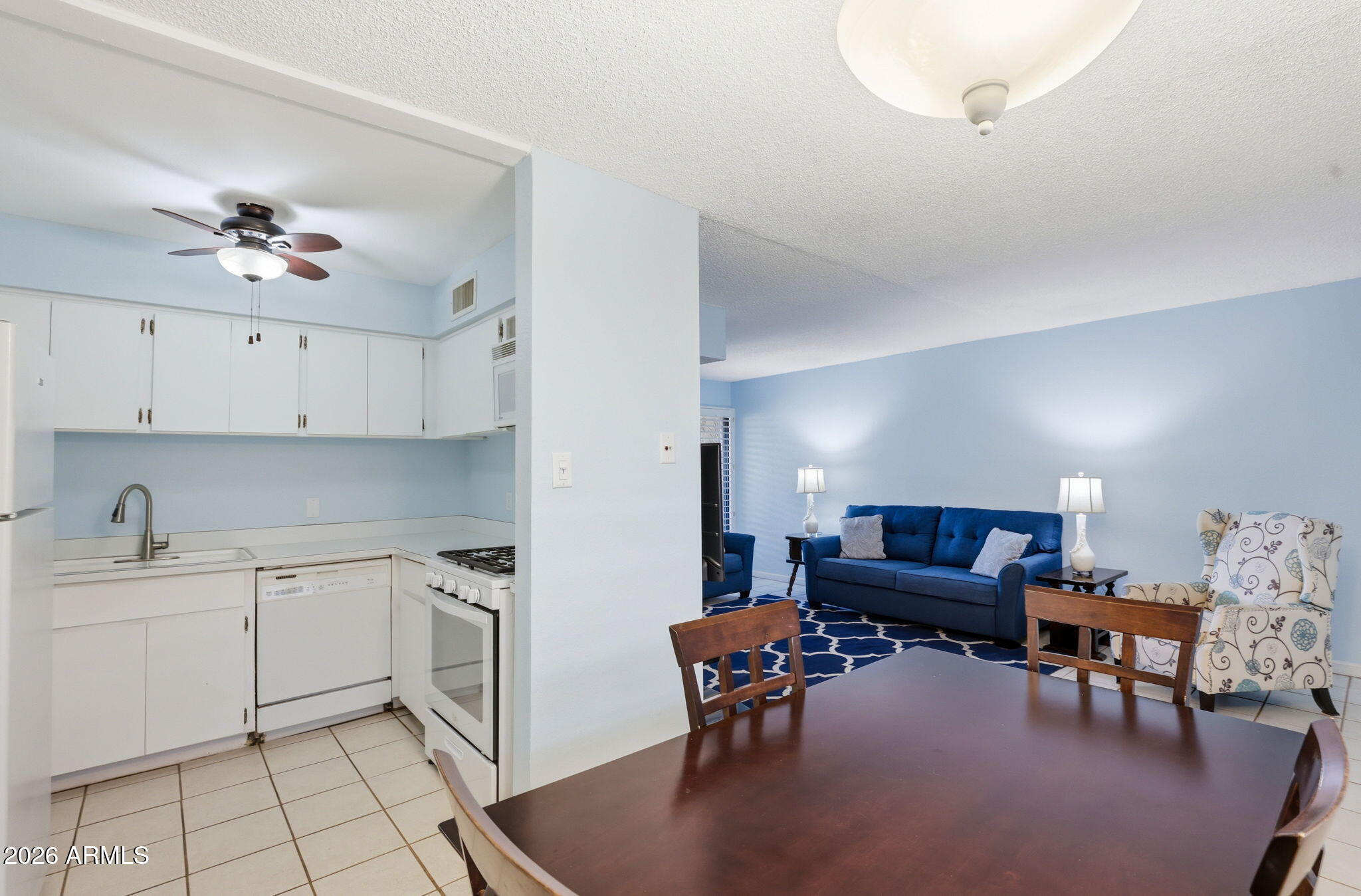 4950 North Miller Road, Unit 339 Scottsdale, AZ 85251 - Photo 15 of 28 a living room with furniture a dining table and chairs