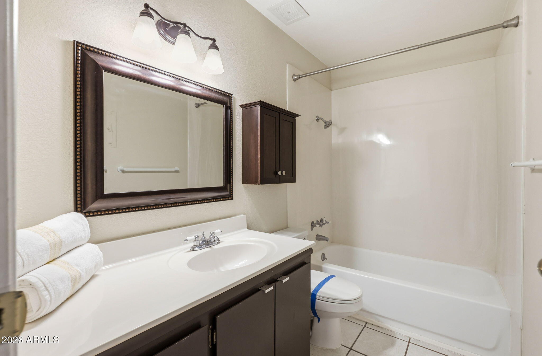 4950 North Miller Road, Unit 339 Scottsdale, AZ 85251 - Photo 19 of 28 a bathroom with a granite countertop sink toilet and shower