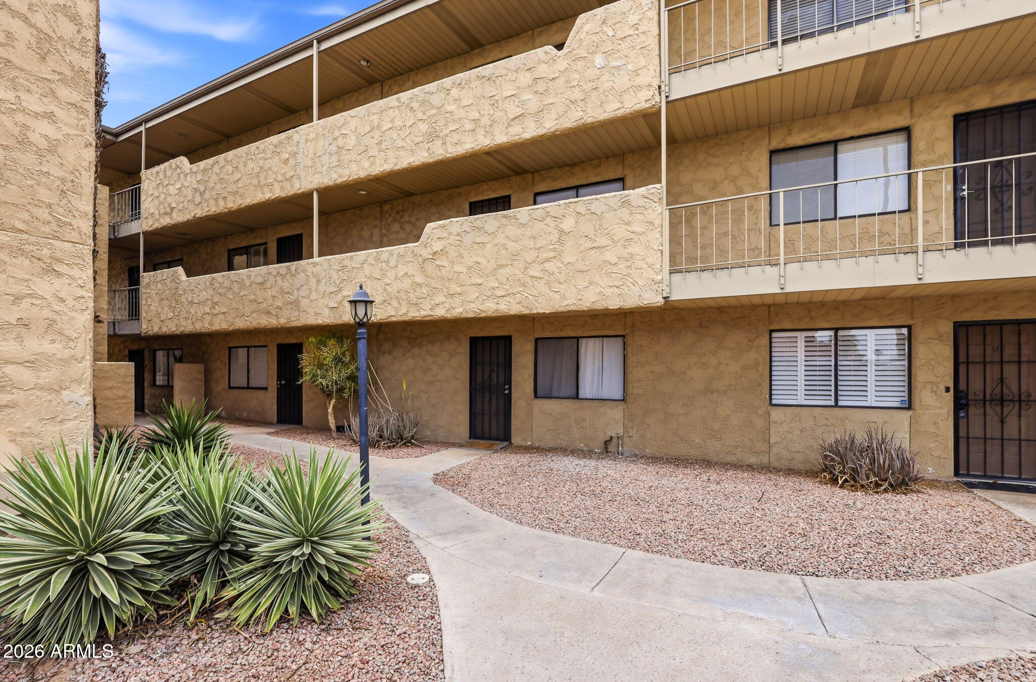 4950 North Miller Road, Unit 339 Scottsdale, AZ 85251 - Photo 5 of 28 a front view of a house with a yard