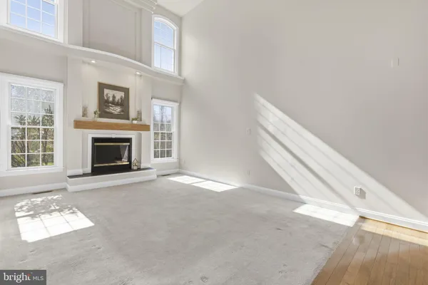 a kitchen with stainless steel appliances granite countertop a refrigerator a sink and white cabinets