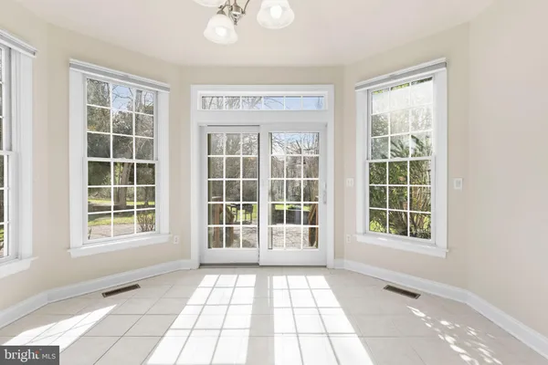 a spacious bedroom with a large bed and a dresser