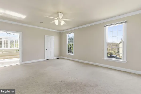 a view of a livingroom with a ceiling fan and window