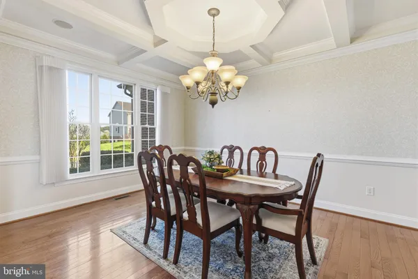 a dining room with furniture a chandelier and a rug
