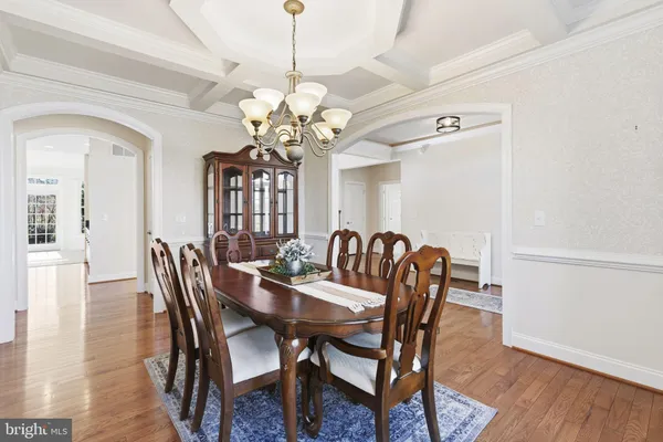 a view of a dining room with furniture wooden floor and chandelier