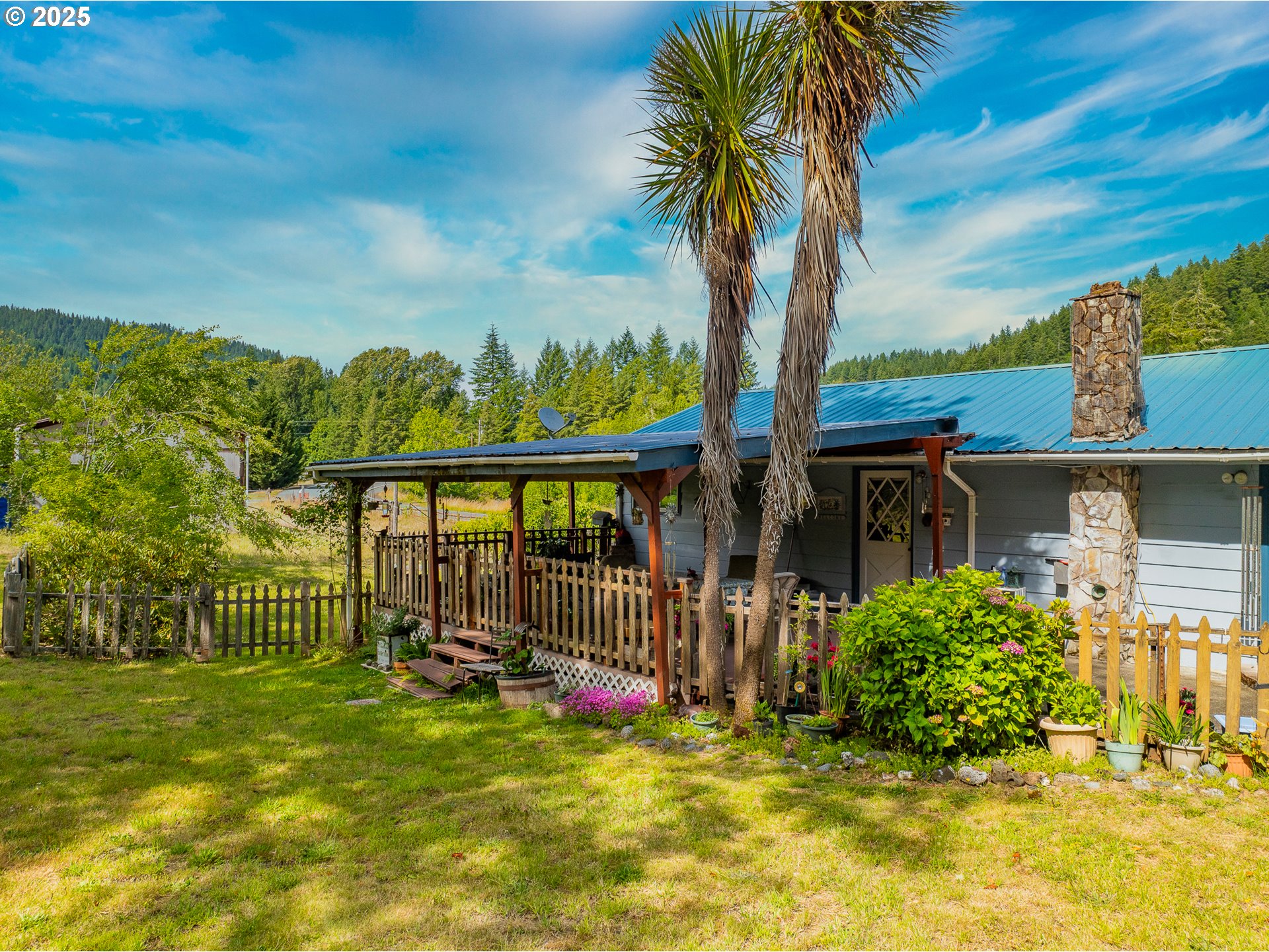 51320 Myrtle Creek Road Myrtle Point, OR 97458 - Photo 12 of 44 a view of a house with a small yard and wooden fence