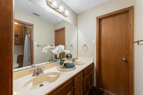 a bathroom with a sink a vanity and a mirror