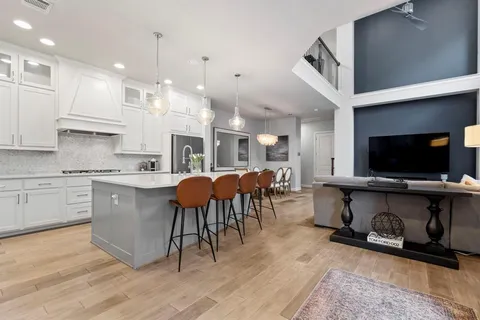 a kitchen with stainless steel appliances kitchen island granite countertop a sink and cabinets