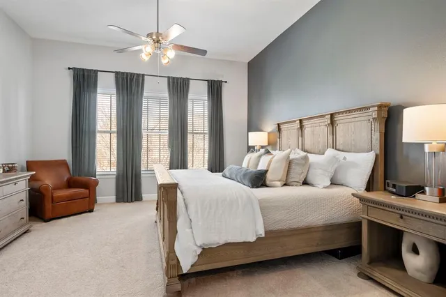 a bedroom with a large bed and a chandelier