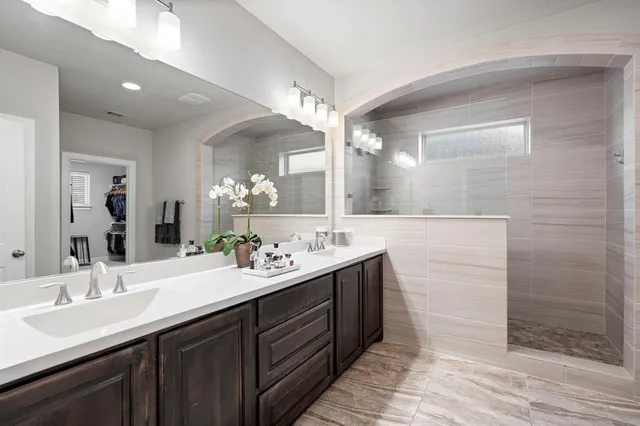 a bathroom with a double vanity sink and a mirror