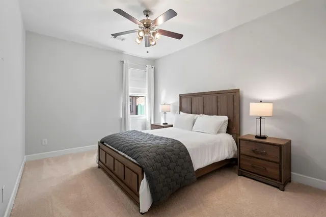 a spacious bedroom with a bed and a table