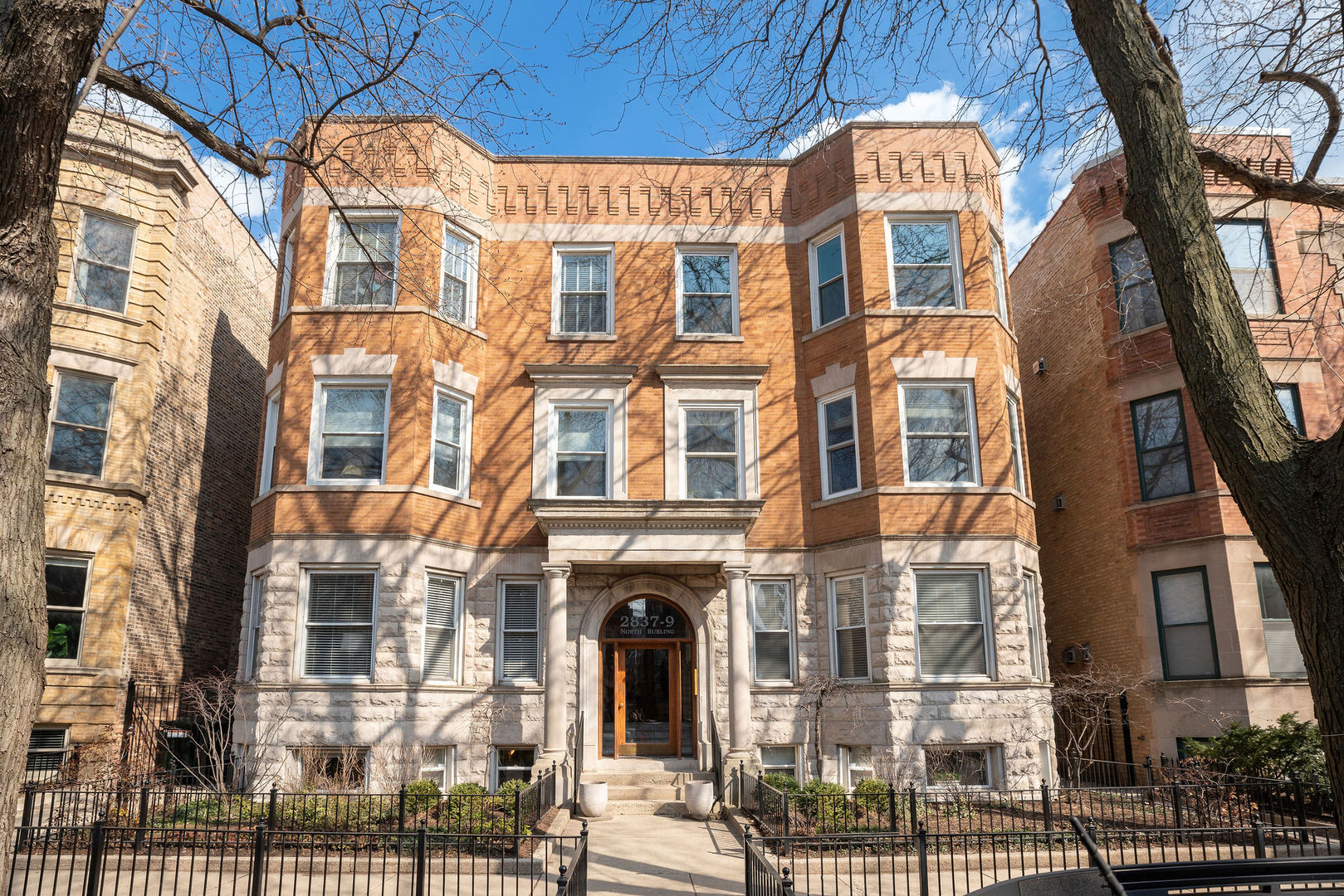 2837 North Burling Street, Unit 1S Chicago, IL 60657 - Photo 1 of 17 a front view of a multi story residential apartment building with a yard