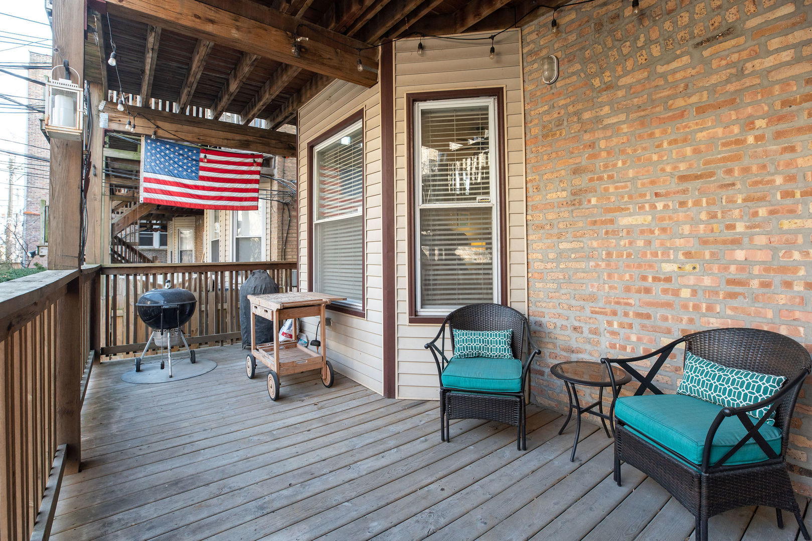 2837 North Burling Street, Unit 1S Chicago, IL 60657 - Photo 16 of 17 a balcony with furniture and wooden floor