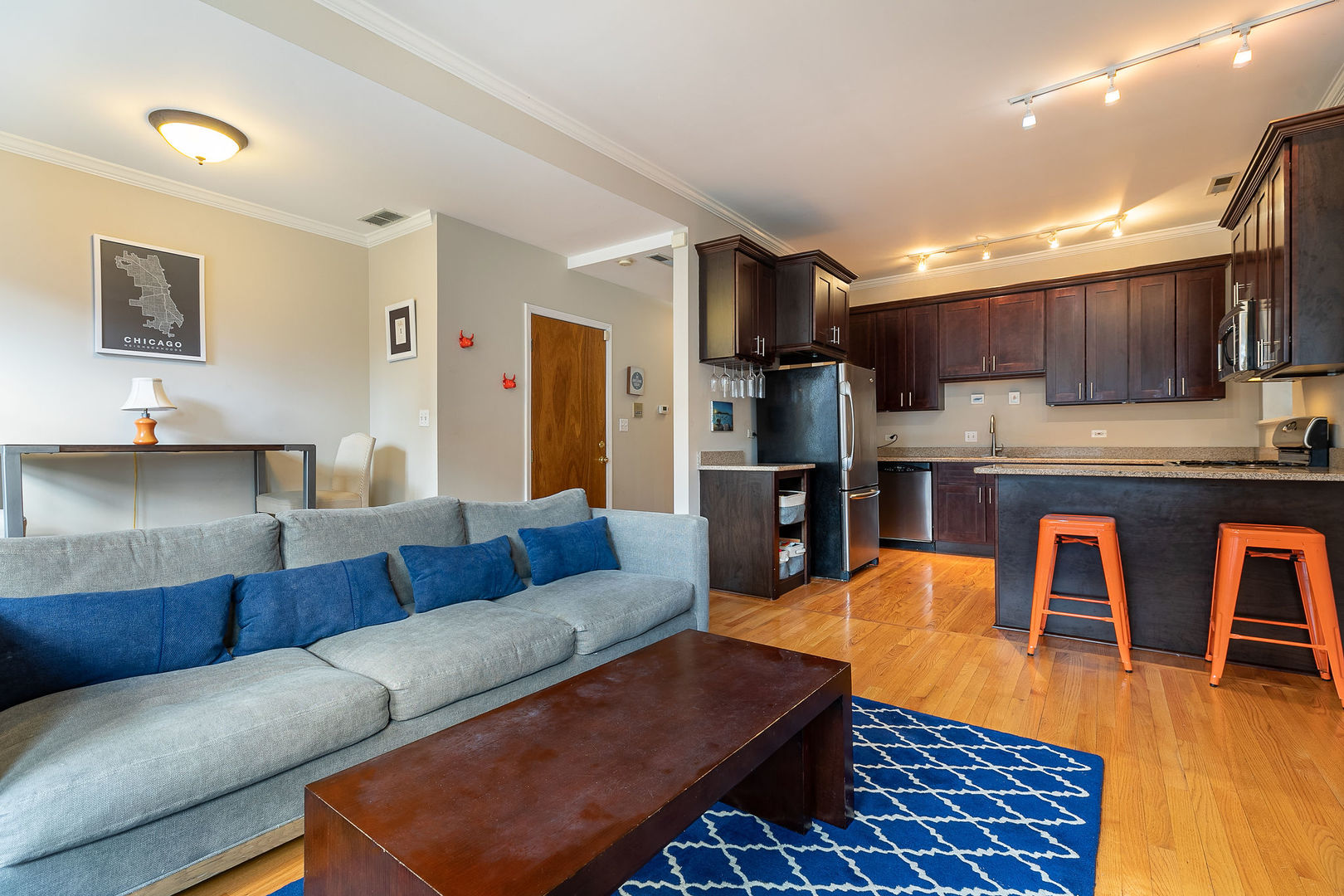 2837 North Burling Street, Unit 1S Chicago, IL 60657 - Photo 5 of 17 a living room with furniture a kitchen view and a sink