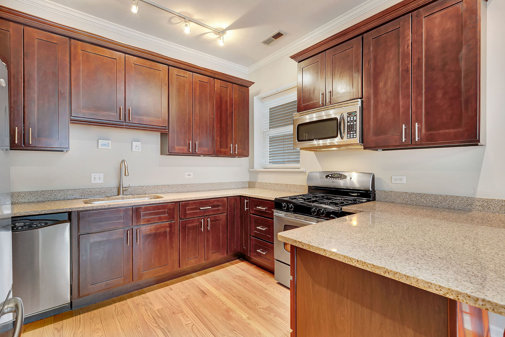 2837 North Burling Street, Unit 1S Chicago, IL 60657 - Photo 6 of 17 a kitchen with wooden cabinets and a sink