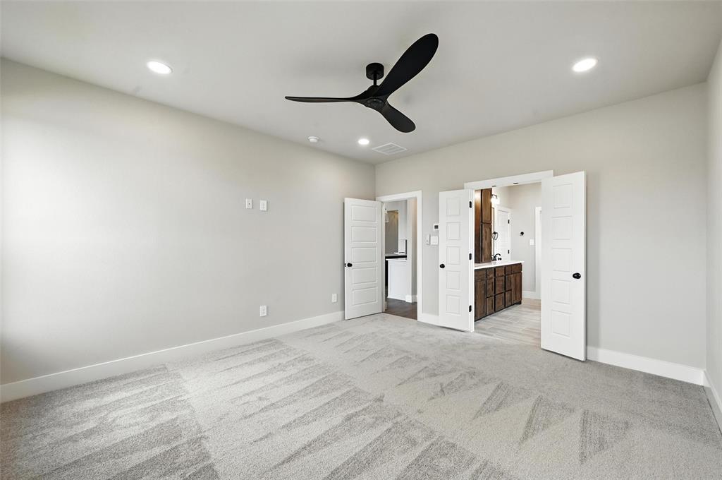 224 Kilkenny Road Poolville, TX 76487 - Photo 12 of 32 a view of a livingroom with a ceiling fan & kitchen space