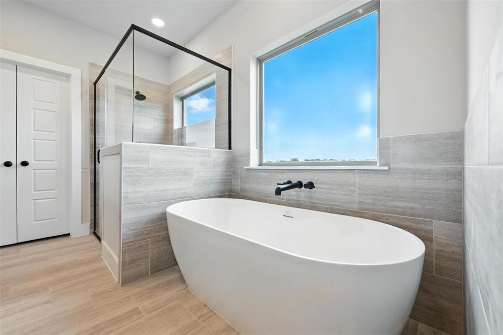 224 Kilkenny Road Poolville, TX 76487 - Photo 16 of 32 a white bath tub sitting in a bathroom and mirror