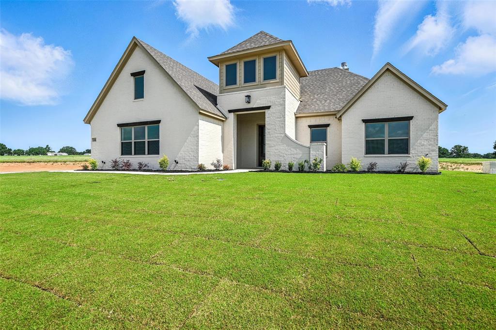 224 Kilkenny Road Poolville, TX 76487 - Photo 2 of 32 a front view of house with yard and green space