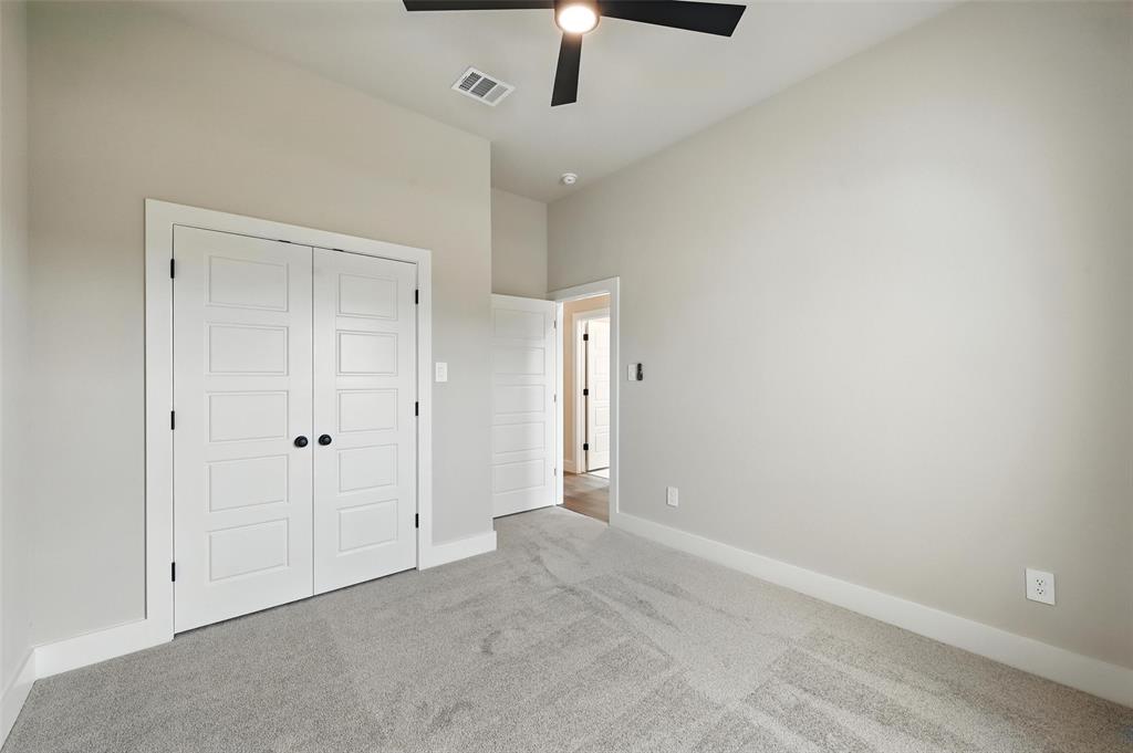 224 Kilkenny Road Poolville, TX 76487 - Photo 21 of 32 a view of an empty room and chandelier fan