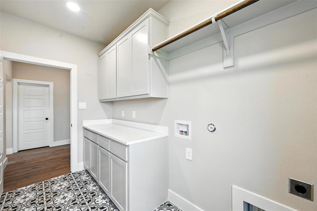 224 Kilkenny Road Poolville, TX 76487 - Photo 26 of 32 a utility room with cabinets washer and dryer