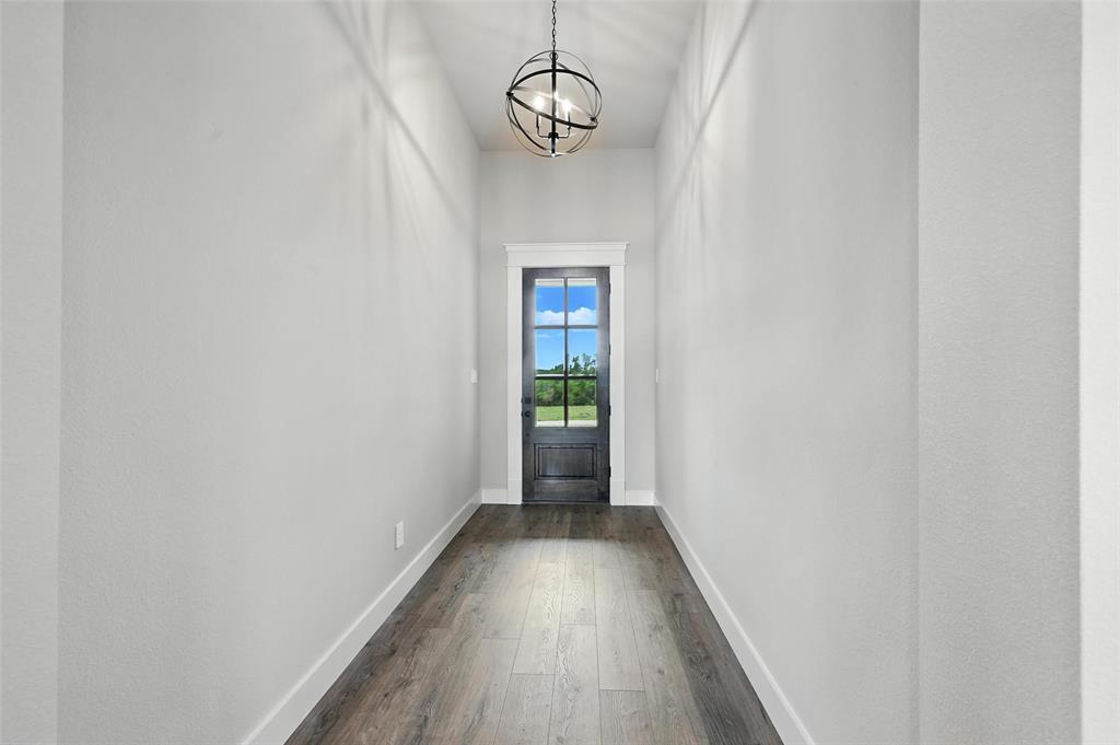 224 Kilkenny Road Poolville, TX 76487 - Photo 3 of 32 a view of a hallway with wooden floor and a window