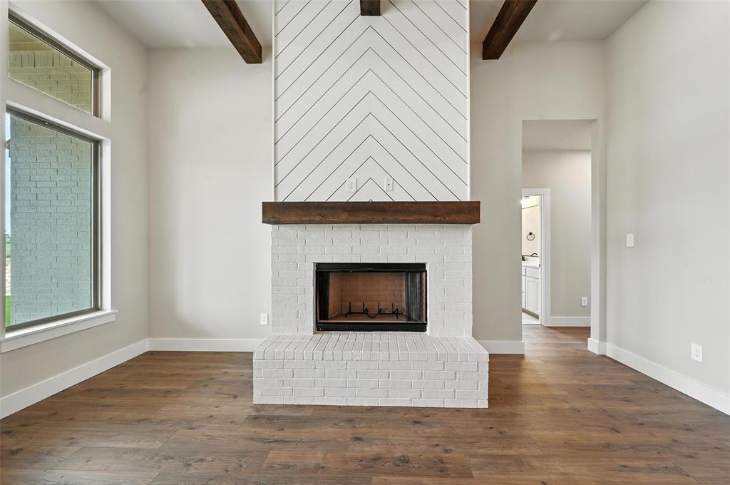 224 Kilkenny Road Poolville, TX 76487 - Photo 8 of 32 a living room with a fireplace and a rug