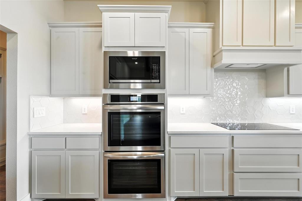 224 Kilkenny Road Poolville, TX 76487 - Photo 9 of 32 a kitchen with cabinets stainless steel appliances and a sink
