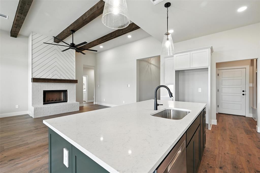 224 Kilkenny Road Poolville, TX 76487 - Photo 10 of 32 a kitchen with a sink a faucet and a refrigerator