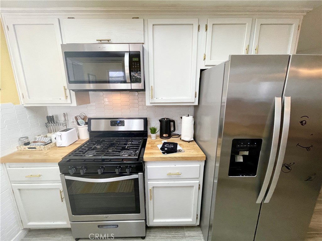 3332 Shamrock Avenue Merced, CA 95340 - Photo 13 of 35 a kitchen with a stove and a microwave
