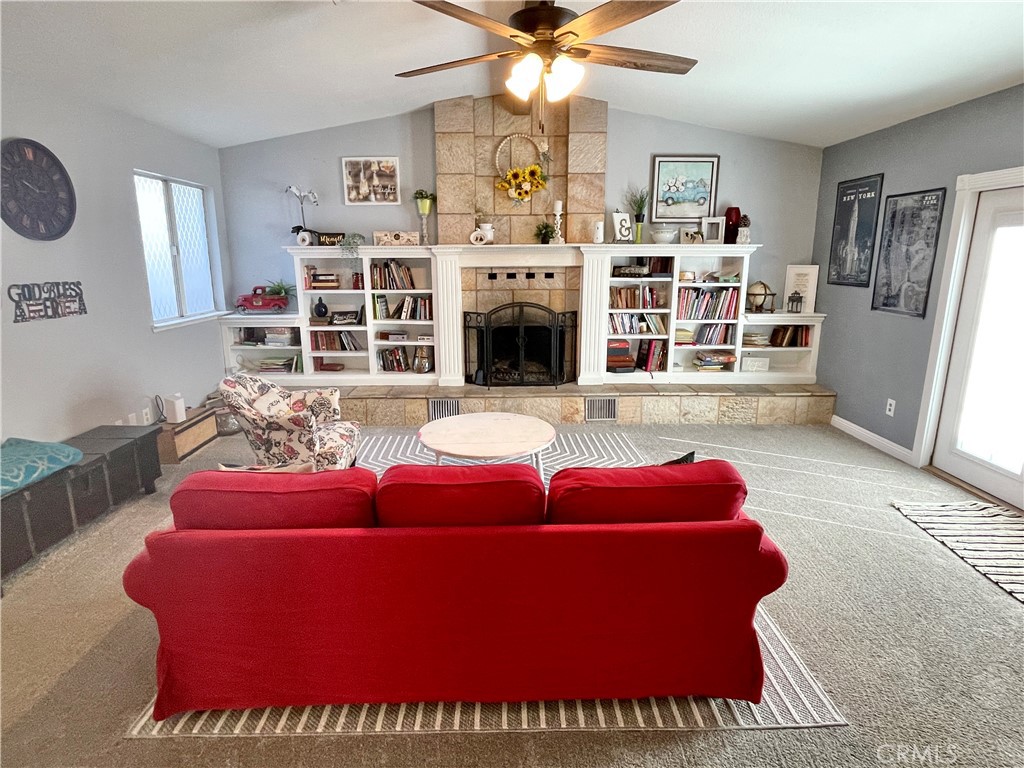 3332 Shamrock Avenue Merced, CA 95340 - Photo 15 of 35 a living room with furniture a fireplace and a chandelier