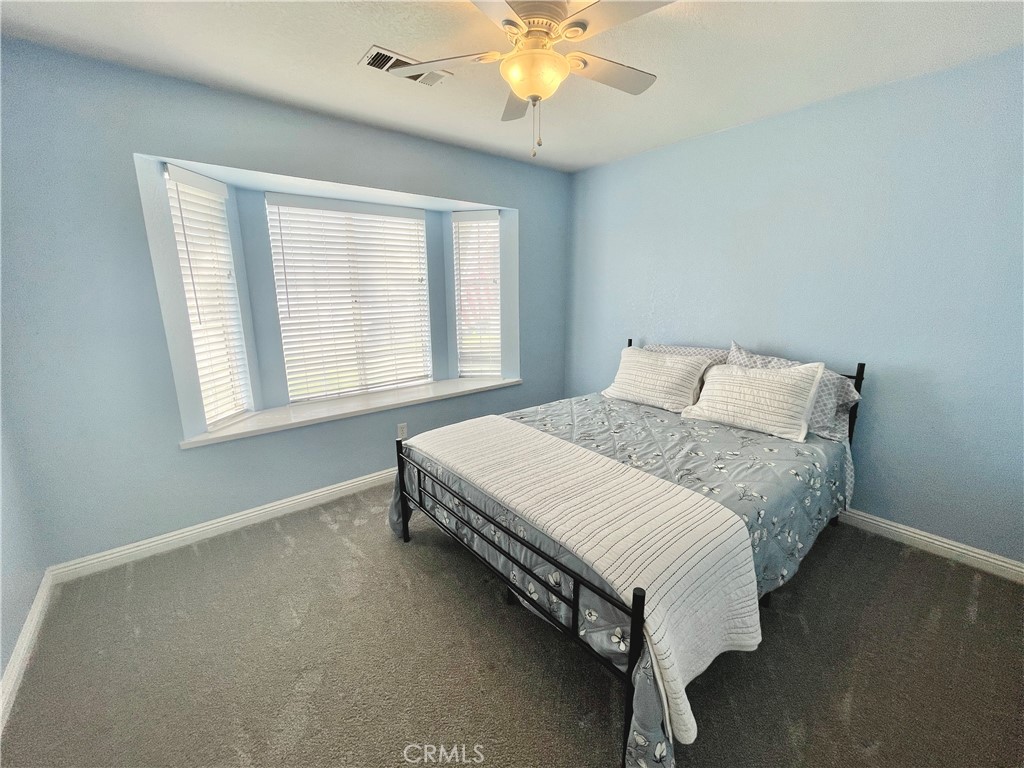 3332 Shamrock Avenue Merced, CA 95340 - Photo 20 of 35 a bed sitting in a bedroom next to a window
