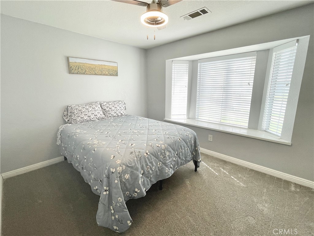 3332 Shamrock Avenue Merced, CA 95340 - Photo 22 of 35 a bed sitting in a bedroom next to a window