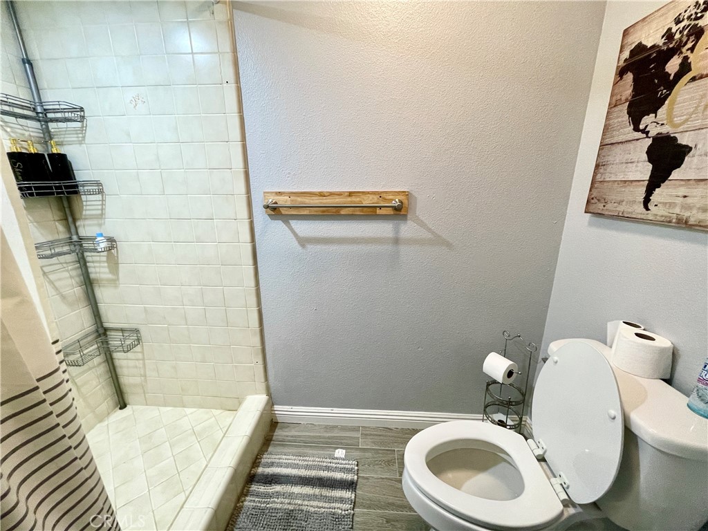 3332 Shamrock Avenue Merced, CA 95340 - Photo 28 of 35 a white toilet sitting next to a bathroom sink