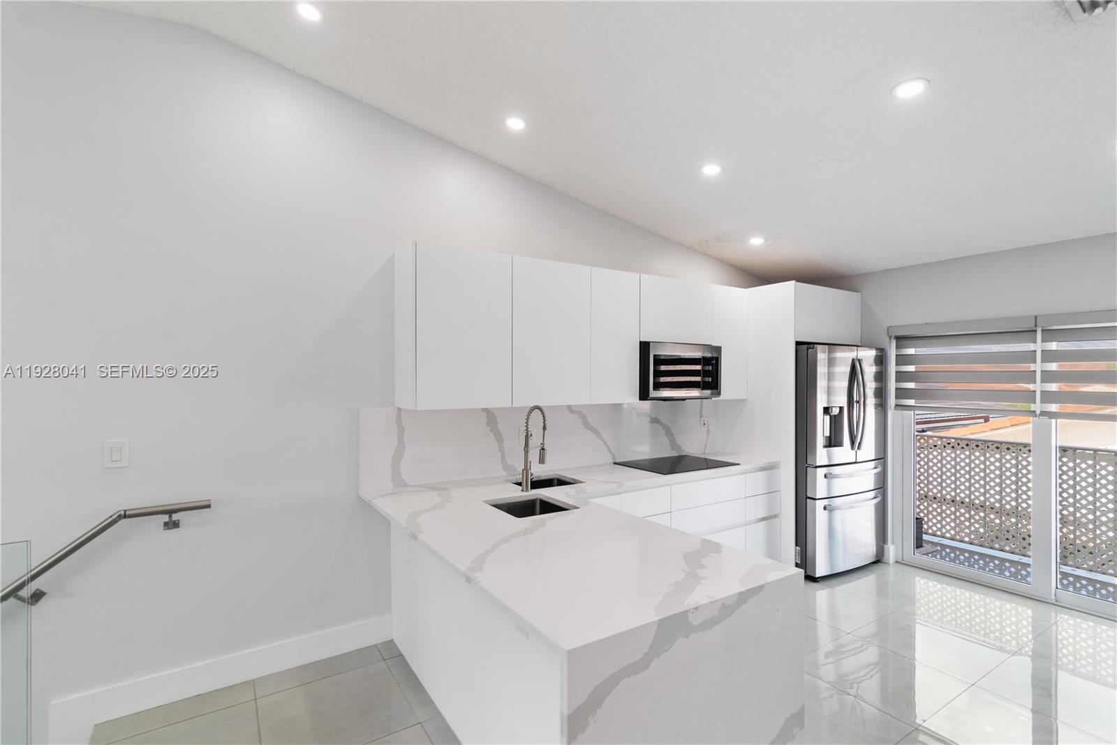 3375 West 76th Street, Unit 210 Hialeah, FL 33018 - Photo 13 of 31 a kitchen with a refrigerator and a counter top space